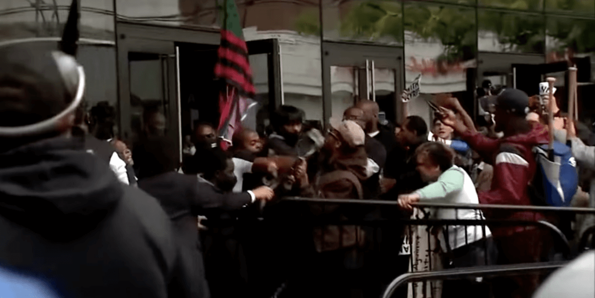 A crowd of people standing around a building.