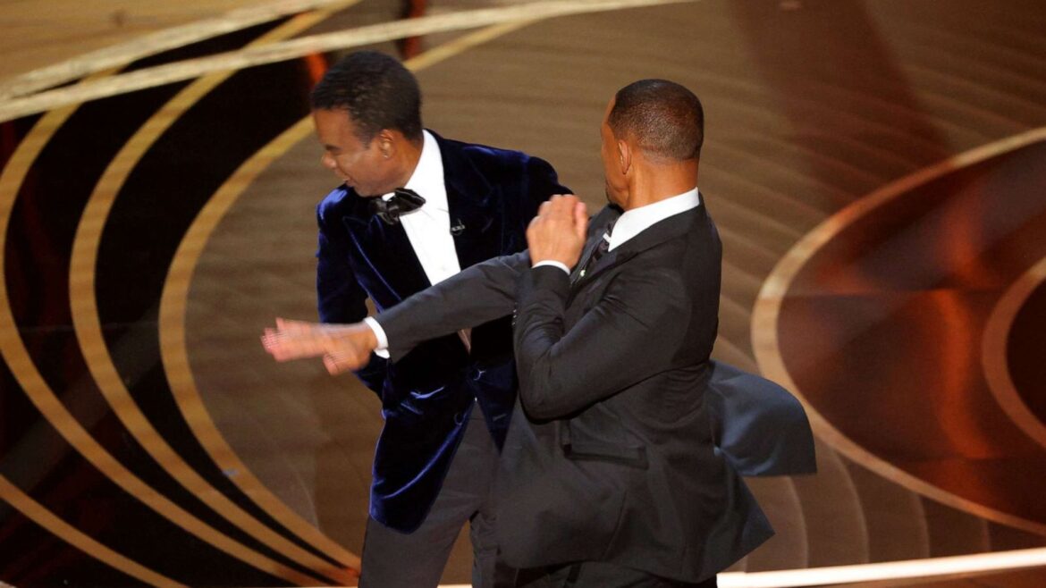 Two men in suits and ties standing next to each other.