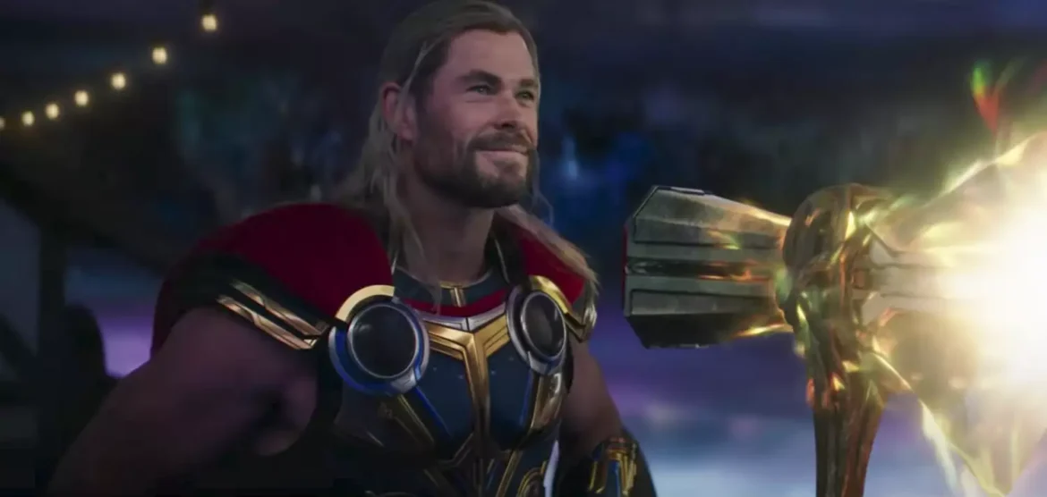 A close up of thor holding a gold staff
