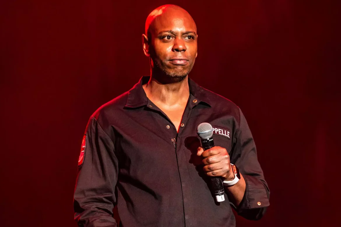 A man holding a microphone on stage.