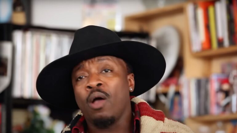 A man in a black hat and jacket.
